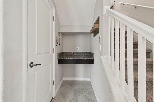 stairs featuring tile patterned floors