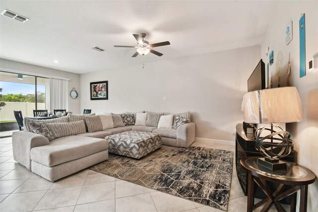 tiled living room featuring ceiling fan