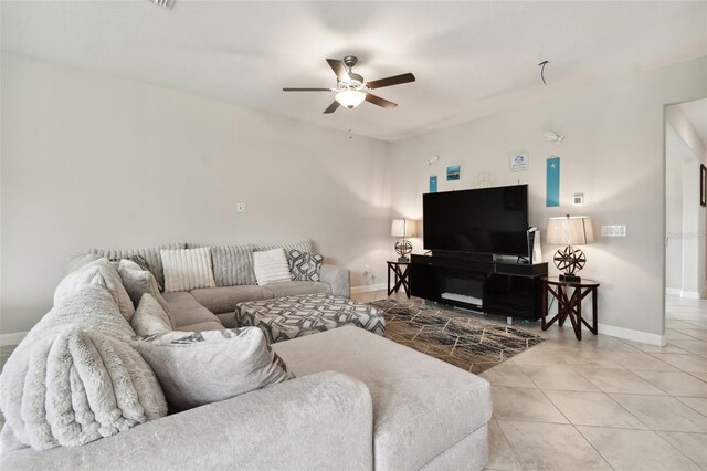 living room with ceiling fan and tile patterned floors