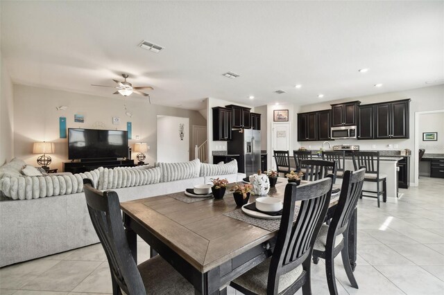 tiled dining room featuring ceiling fan