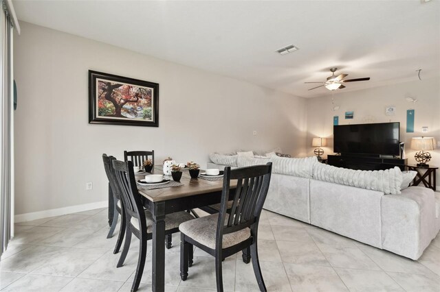 tiled dining area with ceiling fan