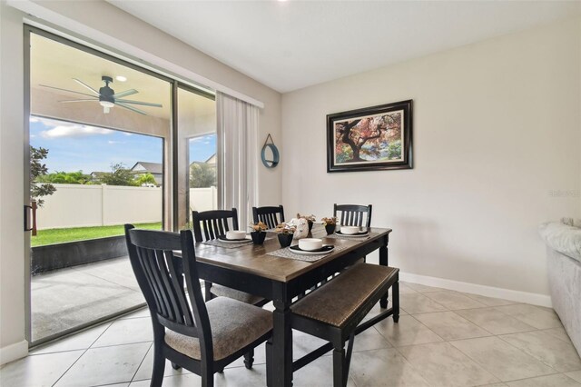 tiled dining space featuring ceiling fan