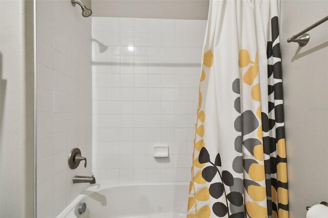 bathroom featuring shower / tub combo with curtain