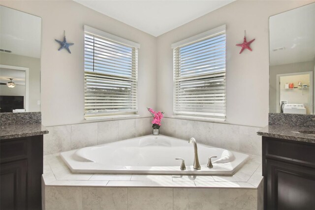 bathroom with vanity and a relaxing tiled tub