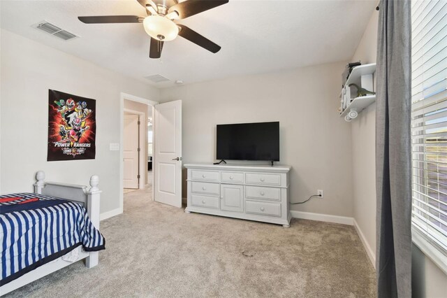 bedroom featuring light colored carpet and ceiling fan