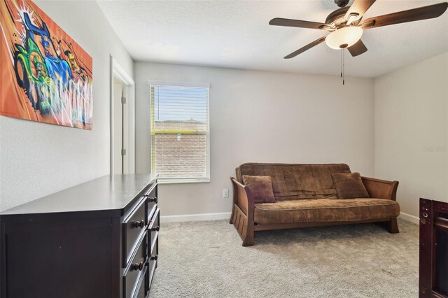 sitting room featuring ceiling fan and light carpet