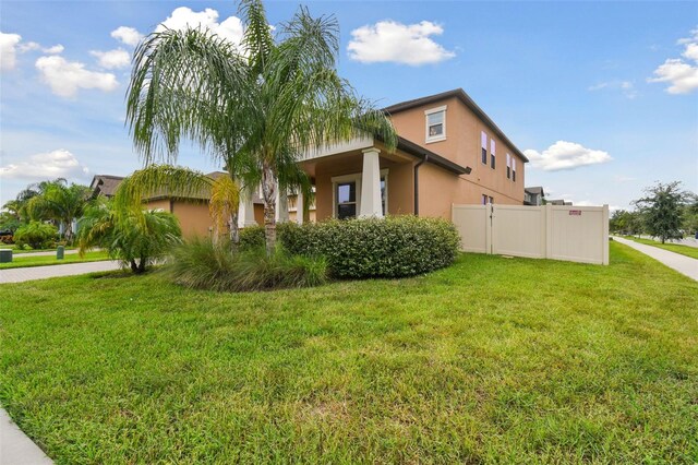 view of property exterior with a lawn