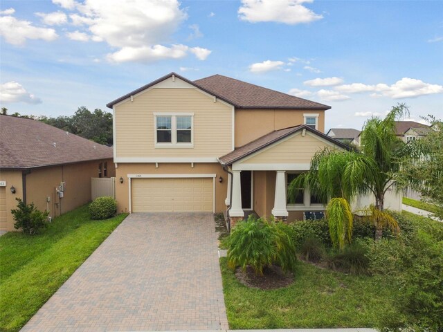 view of front of home with a garage and a front yard