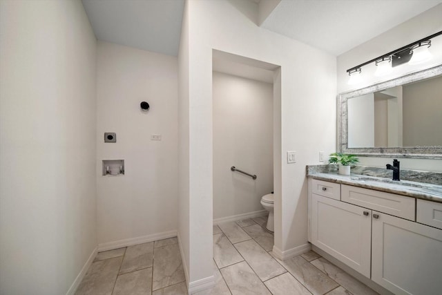 bathroom featuring toilet and vanity