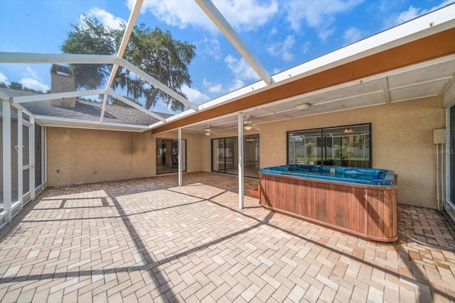 exterior space with a hot tub and lofted ceiling