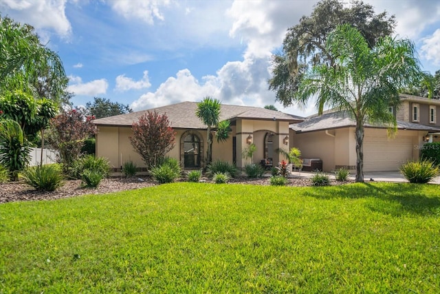 ranch-style house with a garage and a front lawn