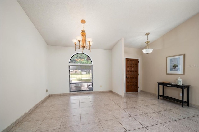 unfurnished room with light tile patterned floors, an inviting chandelier, and a textured ceiling