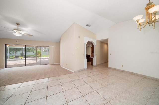 unfurnished room with lofted ceiling, light tile patterned floors, and ceiling fan with notable chandelier