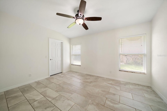 empty room with ceiling fan and lofted ceiling