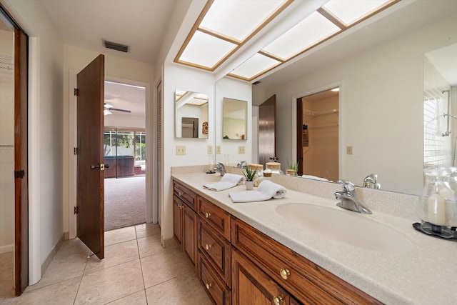 bathroom with ceiling fan, tile patterned floors, and vanity