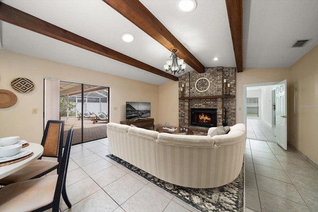 tiled living room featuring lofted ceiling with beams, a fireplace, and a chandelier