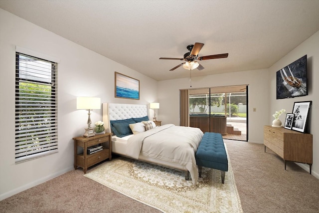 carpeted bedroom featuring a textured ceiling, ceiling fan, and access to exterior