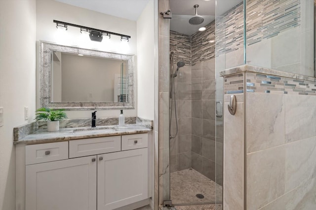 bathroom featuring walk in shower and vanity