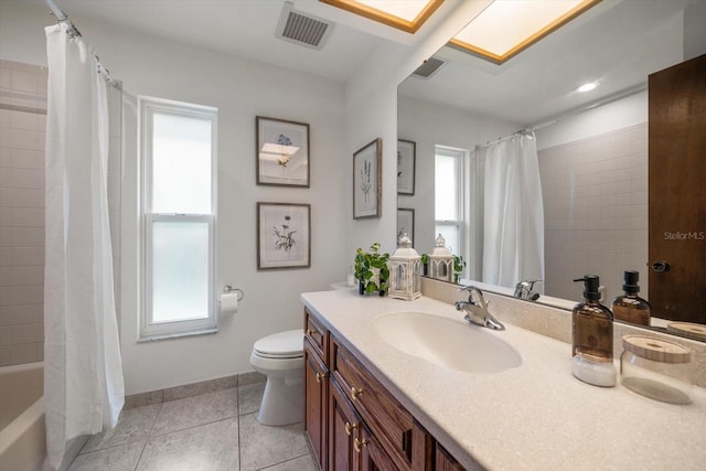 full bathroom featuring a skylight, tile patterned floors, and a wealth of natural light