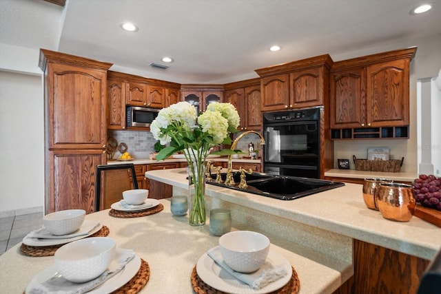 kitchen with decorative backsplash, sink, light tile patterned floors, and double oven