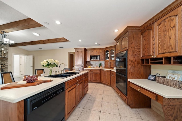 kitchen with a sink, black appliances, a kitchen island with sink, light tile patterned floors, and light countertops