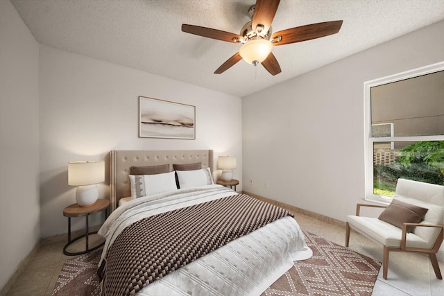 bedroom with a ceiling fan and baseboards