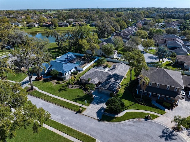 drone / aerial view featuring a water view and a residential view