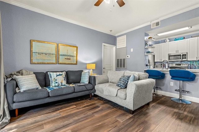 living room with dark wood-type flooring, ceiling fan, and ornamental molding