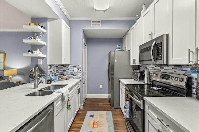 kitchen featuring light stone countertops, stainless steel appliances, decorative backsplash, white cabinetry, and sink