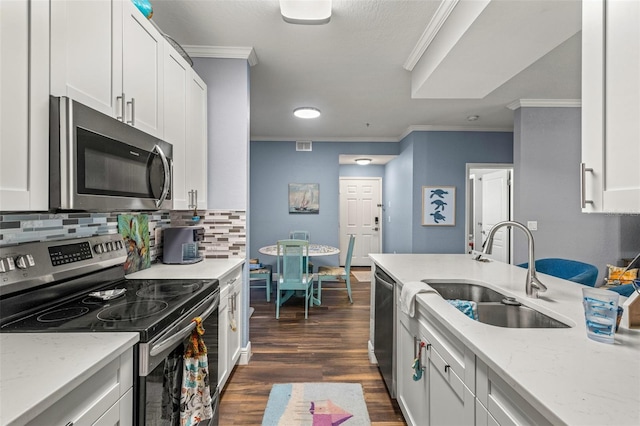 kitchen featuring appliances with stainless steel finishes, white cabinetry, and sink