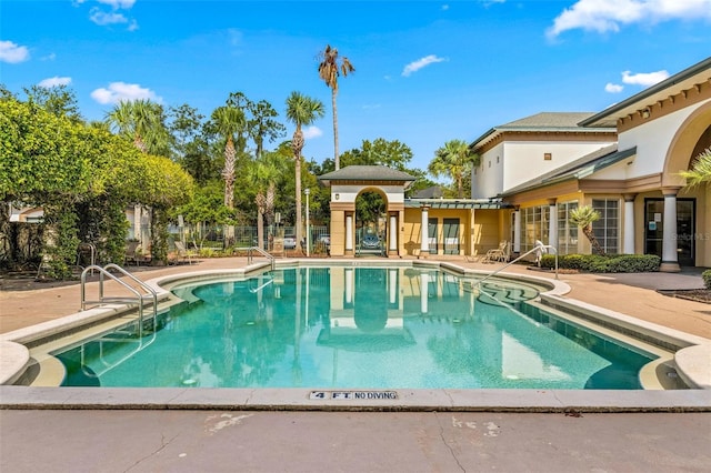 view of swimming pool featuring a patio area