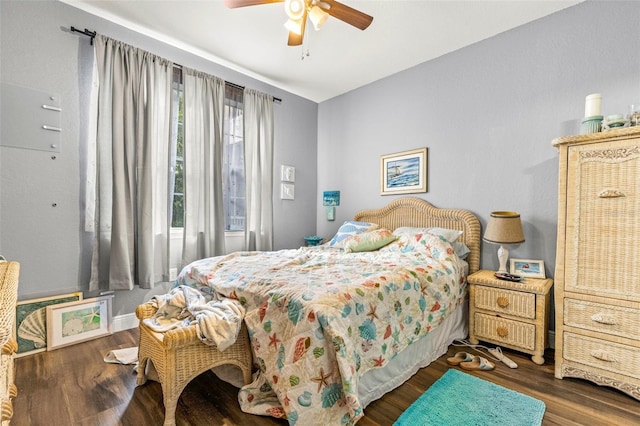 bedroom with ceiling fan and dark hardwood / wood-style flooring