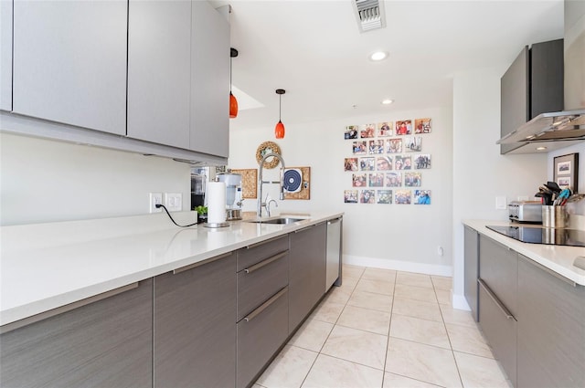 kitchen with black electric stovetop, pendant lighting, gray cabinetry, and stainless steel dishwasher