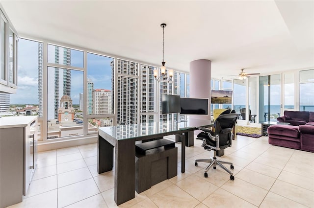 tiled office with ceiling fan with notable chandelier and expansive windows