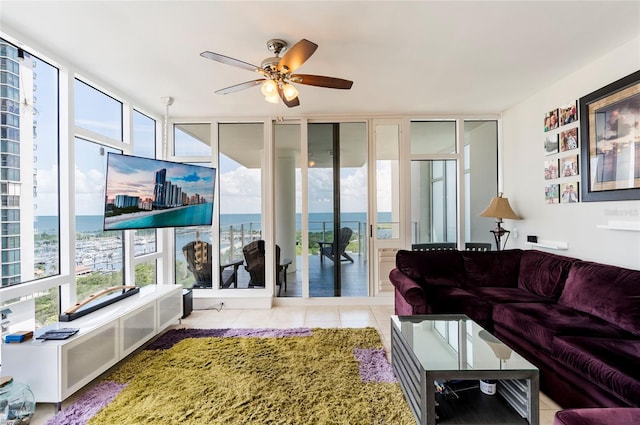 living room with ceiling fan and light tile patterned flooring