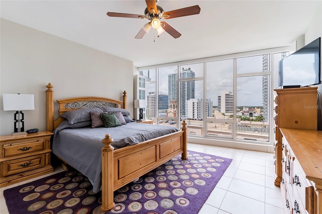 bedroom featuring light tile patterned flooring, floor to ceiling windows, and ceiling fan