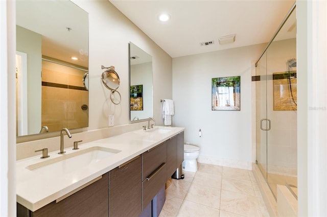 bathroom with tile patterned flooring, toilet, a shower with door, and vanity