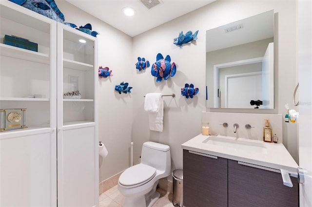 bathroom with vanity, toilet, and tile patterned floors