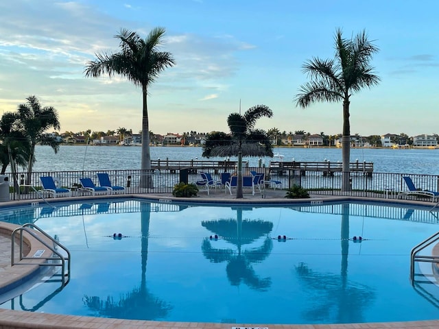 view of swimming pool featuring a water view