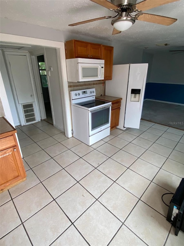 kitchen with white appliances, light tile patterned flooring, and ceiling fan