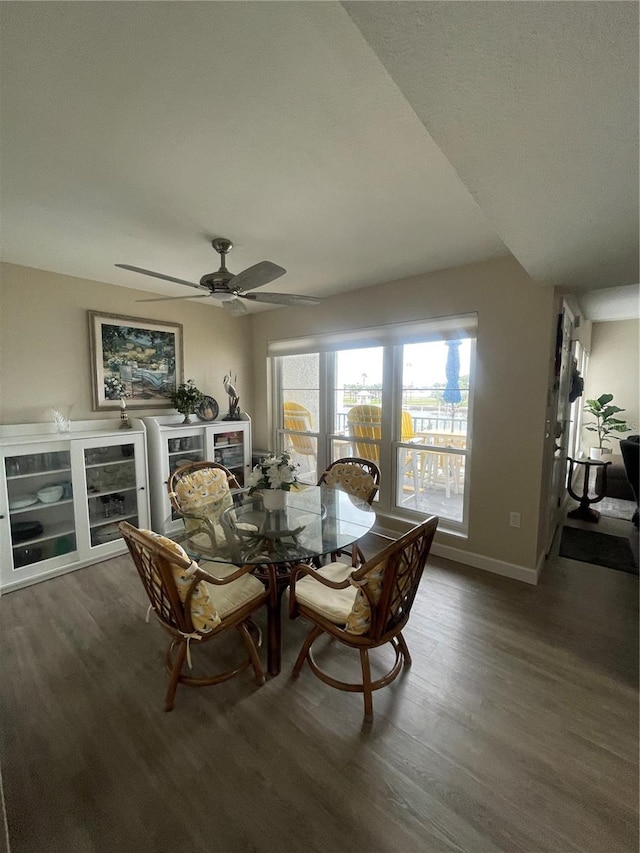 dining area featuring a textured ceiling, ceiling fan, and dark hardwood / wood-style floors