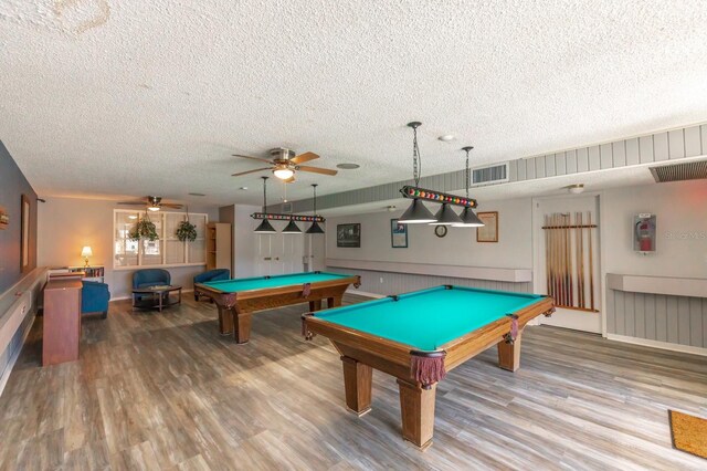 game room featuring a textured ceiling, billiards, wood-type flooring, and ceiling fan