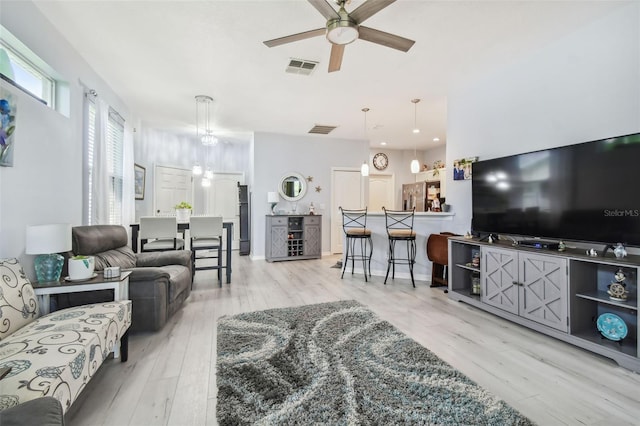 living room with light wood-type flooring and ceiling fan