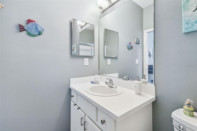 bathroom featuring vanity and toilet