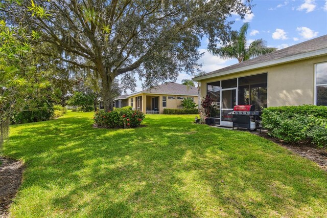 view of yard with a sunroom