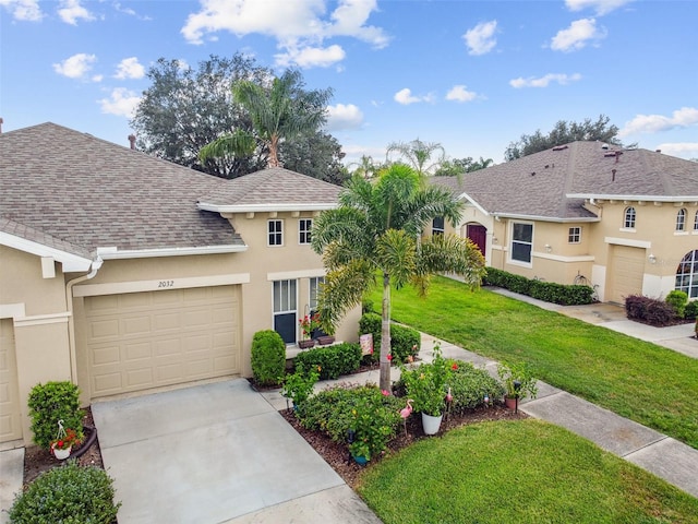 view of front of home with a front lawn and a garage