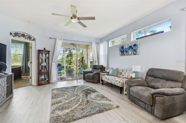 living room with plenty of natural light, ceiling fan, and light hardwood / wood-style floors