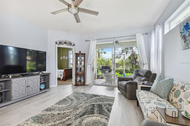 living room featuring light wood-type flooring and ceiling fan