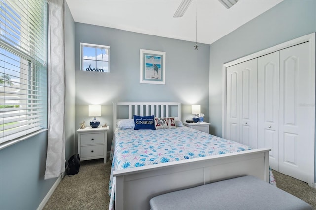 carpeted bedroom featuring multiple windows, ceiling fan, and a closet