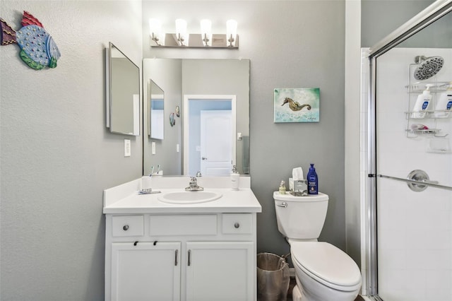 bathroom featuring an enclosed shower, toilet, and vanity